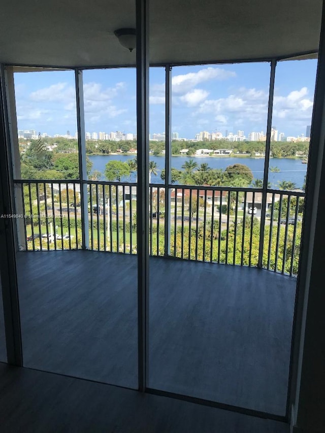 unfurnished sunroom featuring a water view