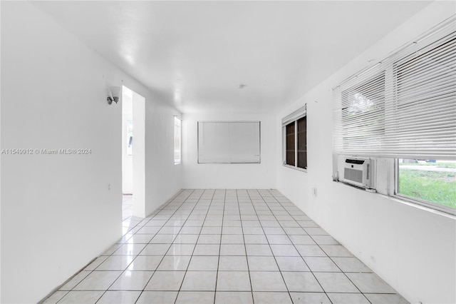 unfurnished room with light tile patterned floors and cooling unit