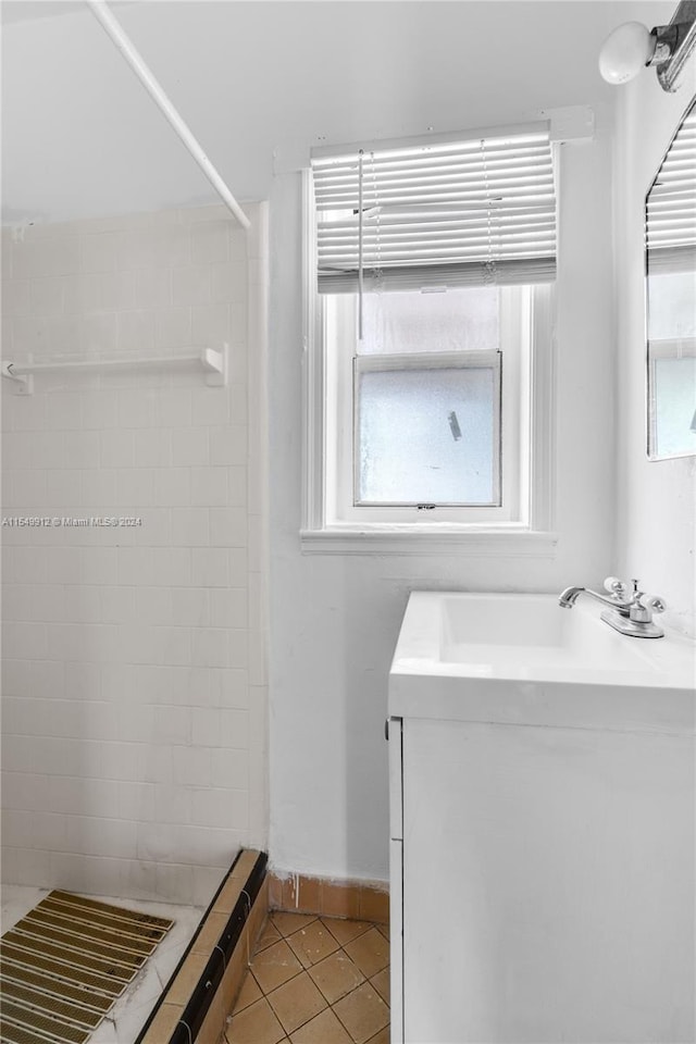 bathroom with vanity, tile patterned floors, and a tile shower