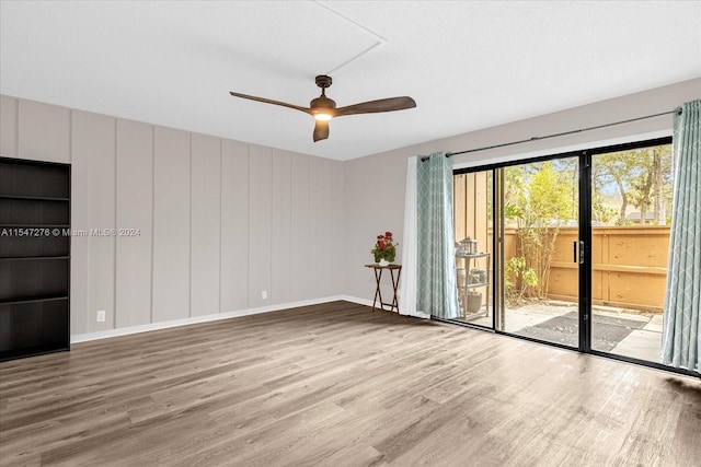 empty room featuring hardwood / wood-style floors and ceiling fan