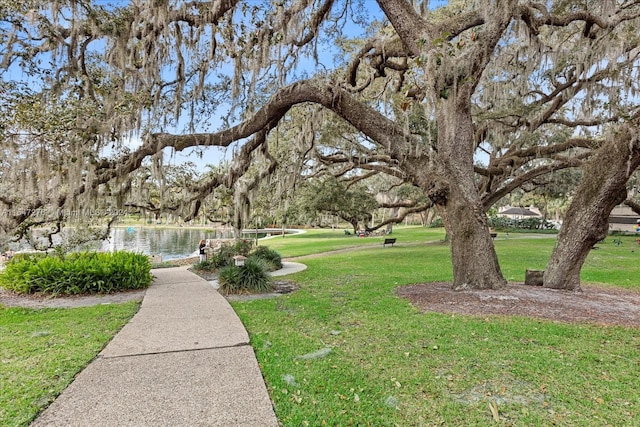 surrounding community featuring a yard and a water view
