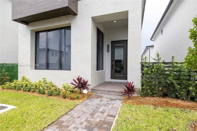 doorway to property featuring a yard