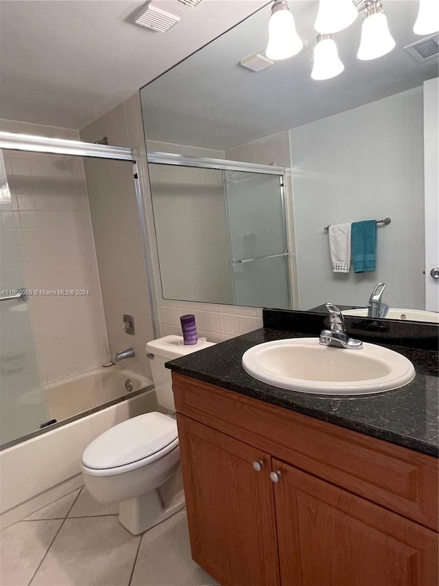 full bathroom with vanity, shower / bath combination with glass door, tile floors, and toilet