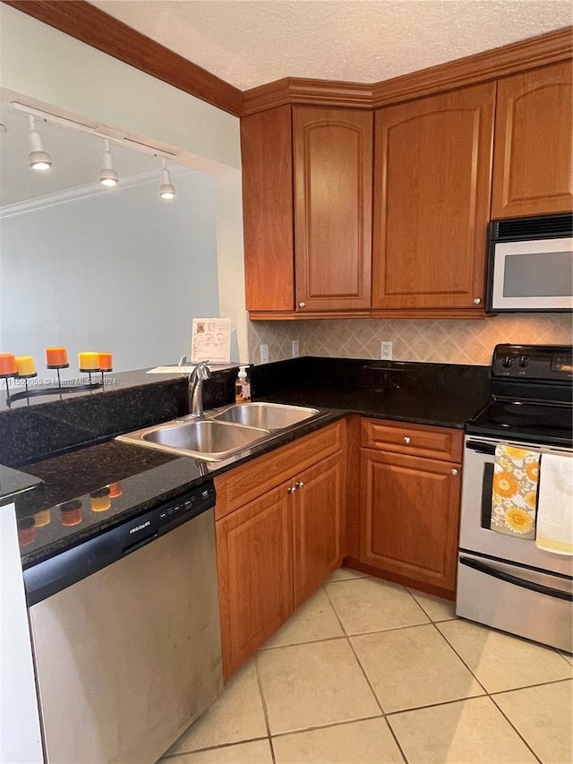 kitchen with electric stove, stainless steel dishwasher, crown molding, track lighting, and sink