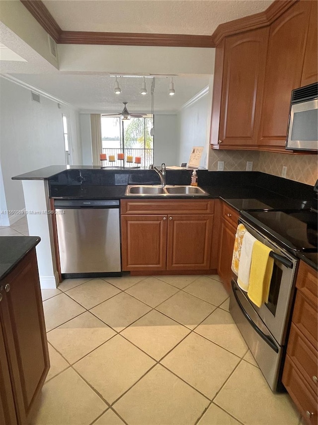 kitchen featuring stainless steel appliances, light tile floors, tasteful backsplash, ornamental molding, and sink