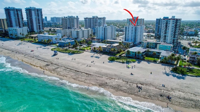 bird's eye view with a beach view and a water view