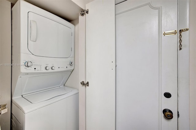 washroom featuring stacked washer and clothes dryer