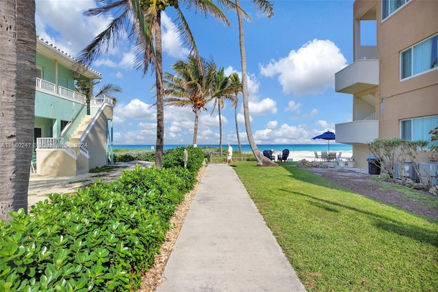 view of home's community featuring a yard and a water view