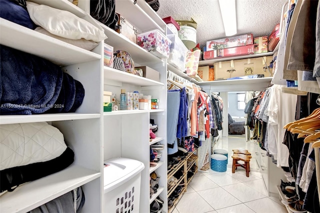 walk in closet featuring light tile floors