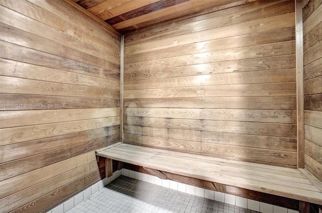 view of sauna with wooden ceiling, wood walls, and tile floors