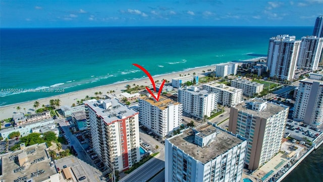 bird's eye view featuring a water view and a view of the beach