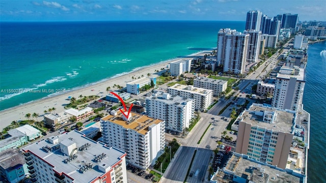 birds eye view of property featuring a beach view and a water view