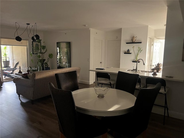 dining area with dark wood-type flooring and sink