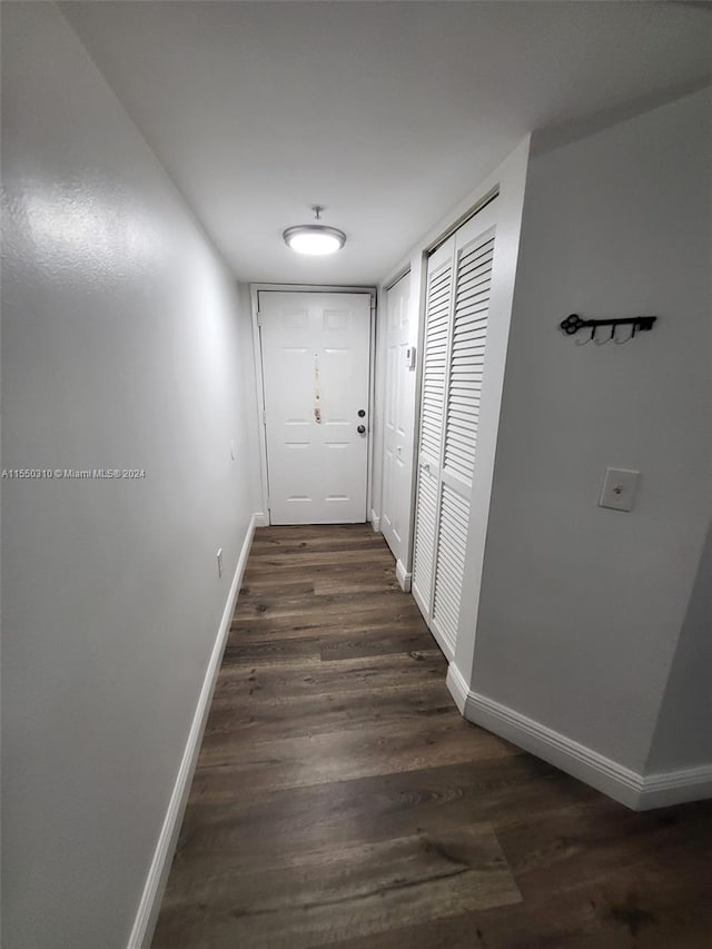 hall with dark hardwood / wood-style flooring