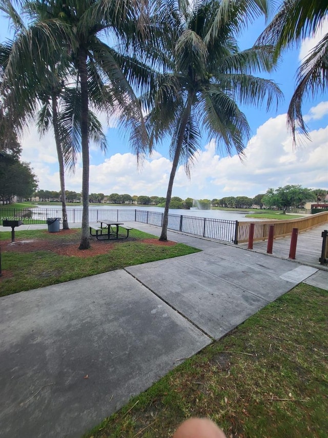 view of property's community with a lawn