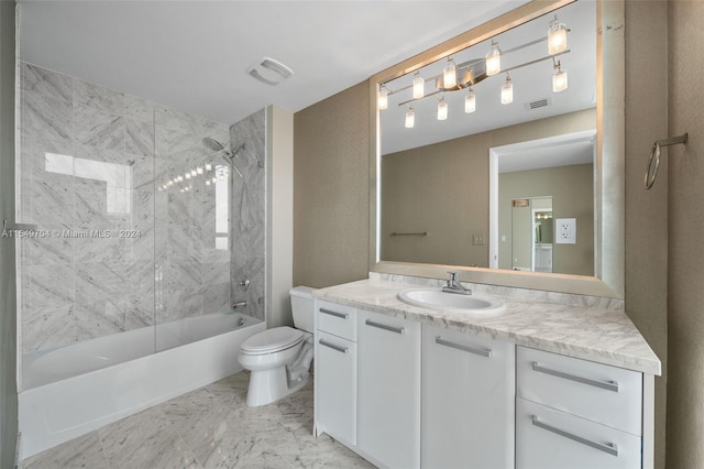 full bathroom featuring toilet, vanity with extensive cabinet space, tiled shower / bath, and tile flooring