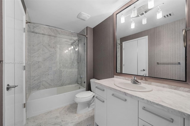 full bathroom featuring vanity, toilet, tiled shower / bath, and tile flooring