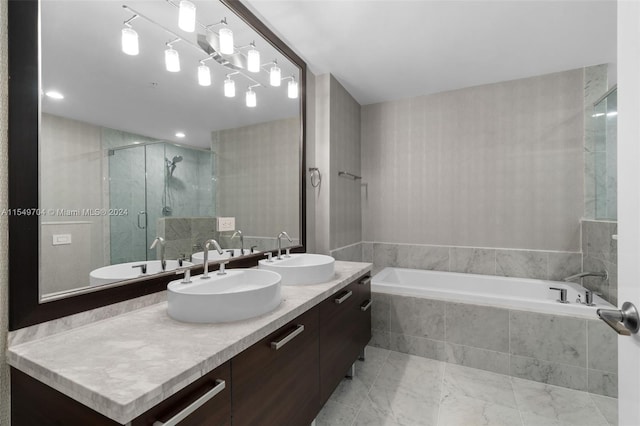 bathroom featuring plus walk in shower, tile floors, and double vanity