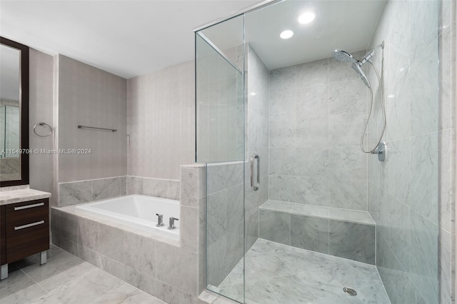 bathroom featuring tile flooring, vanity, and shower with separate bathtub