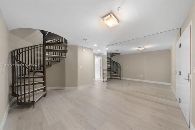 basement featuring light hardwood / wood-style flooring