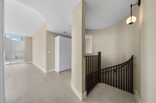 corridor with light hardwood / wood-style flooring