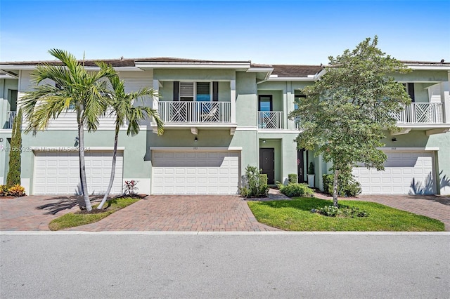 view of front of property with a balcony and a garage