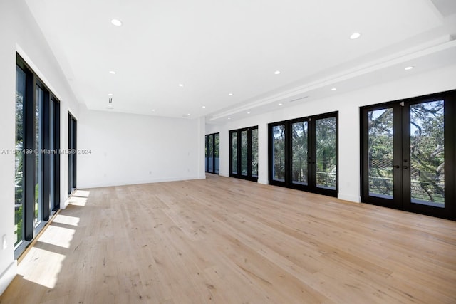 unfurnished room with light wood-type flooring and french doors