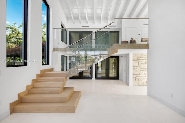 stairway featuring tile floors and french doors