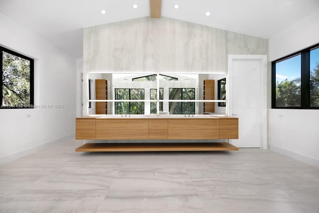 interior space with vaulted ceiling with beams and vanity