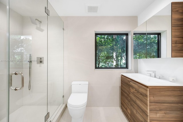 bathroom featuring walk in shower, vanity, toilet, and tile floors