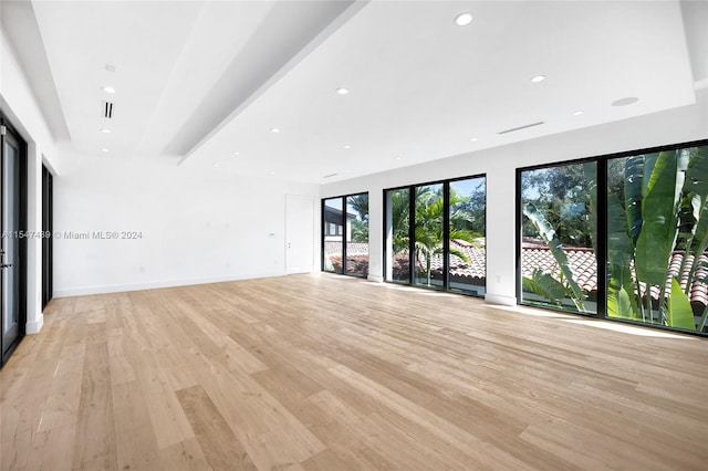 spare room with light hardwood / wood-style flooring