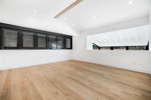 unfurnished room featuring light hardwood / wood-style flooring and vaulted ceiling