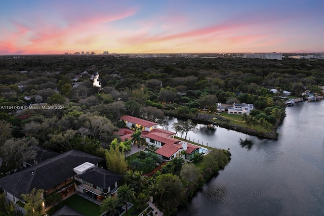 aerial view at dusk with a water view