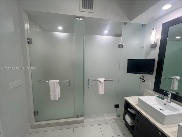 bathroom featuring vanity, tile patterned floors, and walk in shower