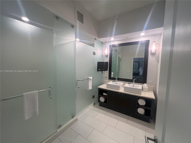 bathroom featuring vanity, tile patterned floors, and a shower with door