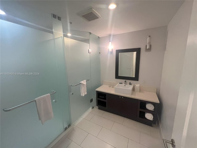 bathroom with vanity, tile patterned floors, and a shower with door