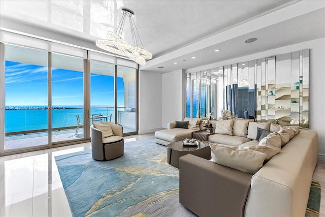 living room with a water view and an inviting chandelier