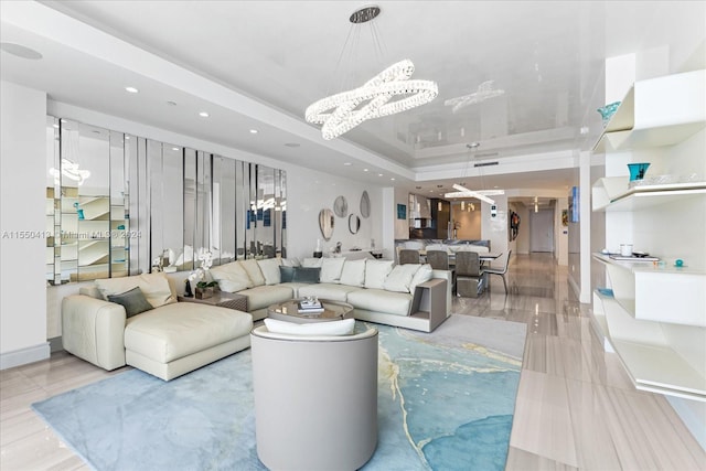 interior space with a tray ceiling and a chandelier