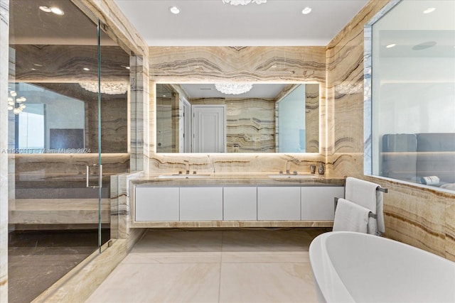 bathroom with an inviting chandelier, tile flooring, independent shower and bath, and double vanity