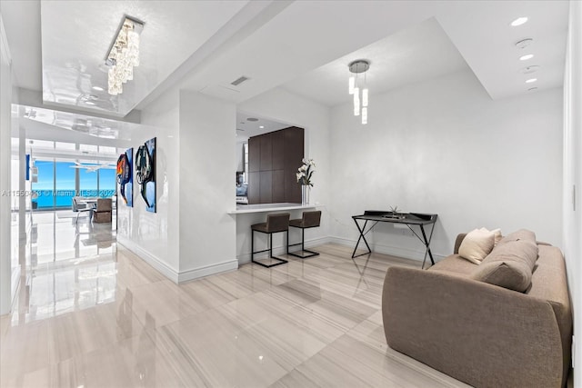 living room featuring a chandelier, floor to ceiling windows, and light tile floors