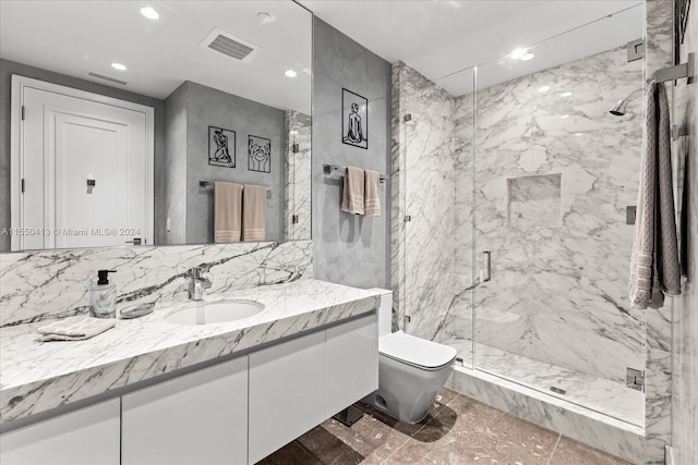 bathroom with vanity, tile walls, tile floors, a shower with door, and toilet