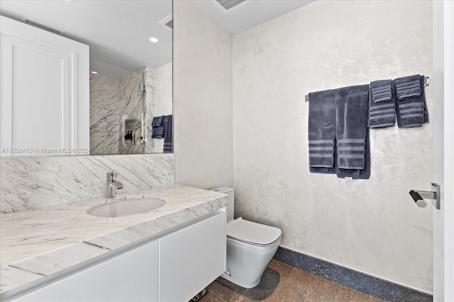 bathroom featuring tile floors, toilet, and vanity