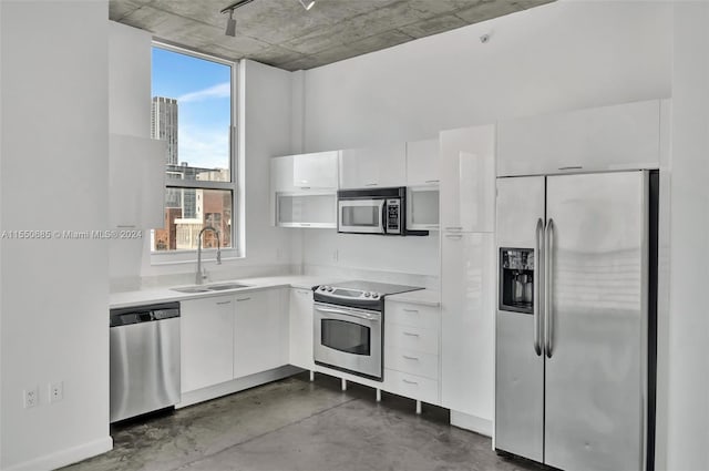 kitchen featuring sink, white cabinets, and appliances with stainless steel finishes