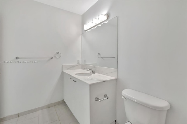 bathroom featuring tile patterned flooring, vanity, and toilet