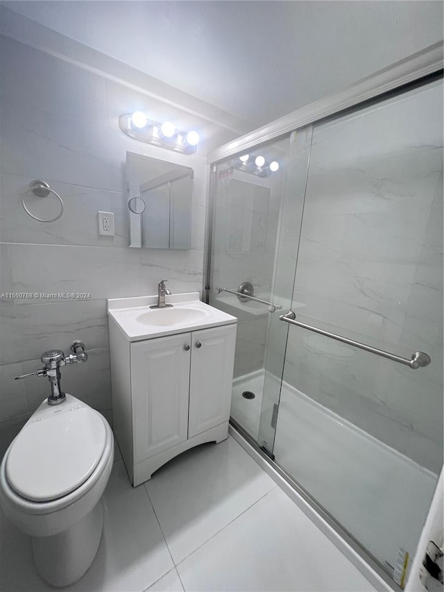 bathroom featuring toilet, vanity, tile walls, tile floors, and an enclosed shower