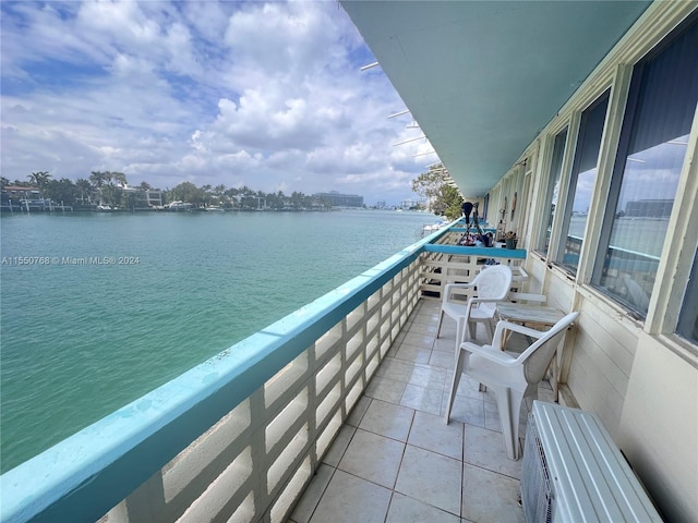 balcony featuring a water view and radiator