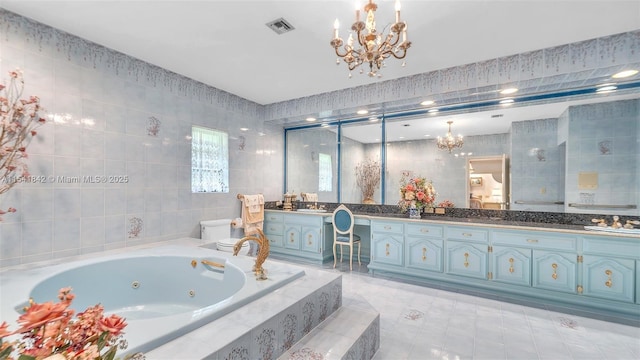 bathroom featuring tile patterned floors, vanity, tile walls, a notable chandelier, and a relaxing tiled tub