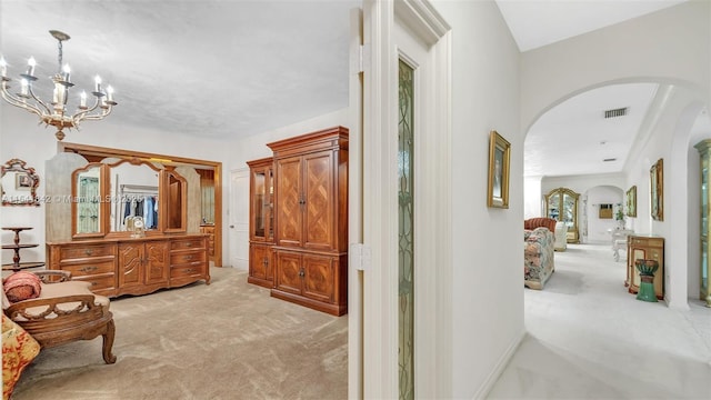 living area featuring an inviting chandelier and light carpet