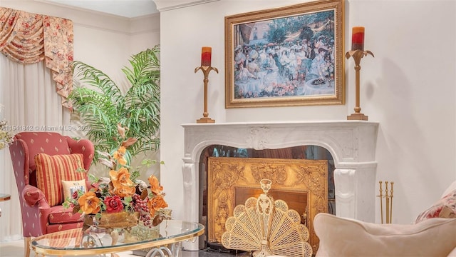 living area featuring crown molding and a fireplace