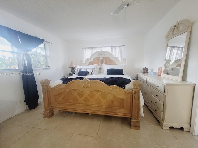 tiled bedroom with ceiling fan